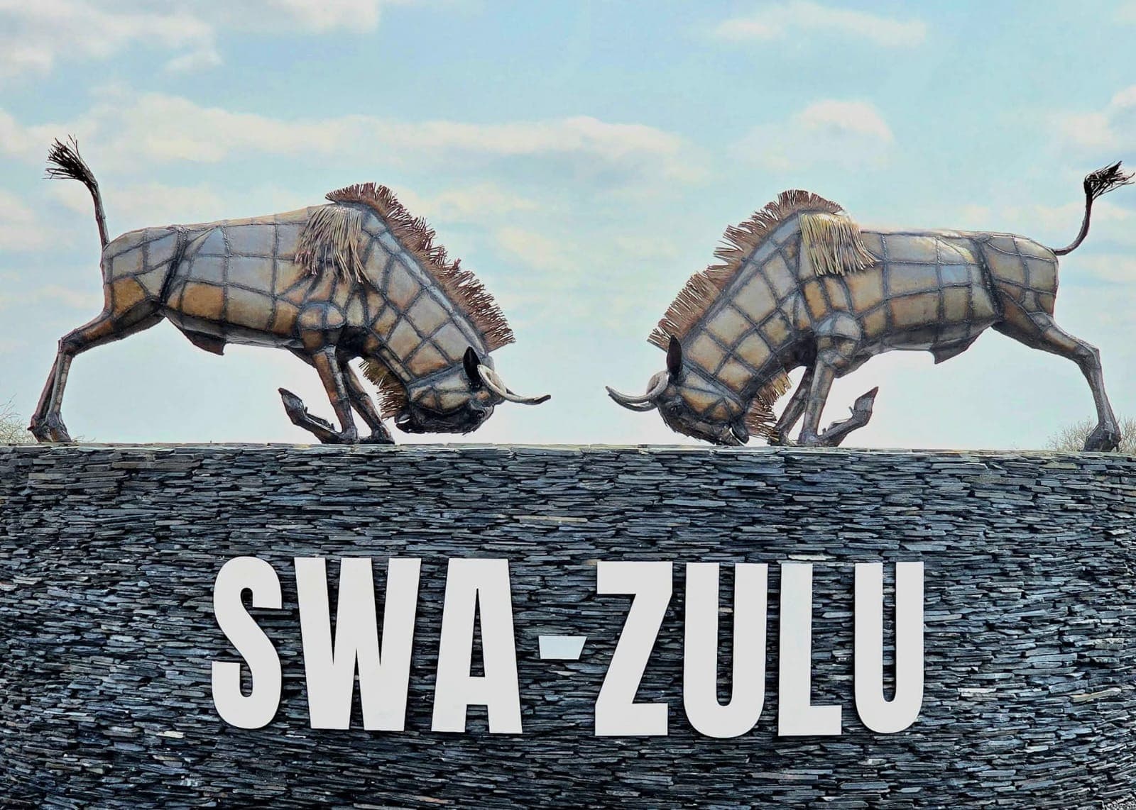The Swa-Zulu Game Lodge stone entrance with its signature wildebeest sculptures